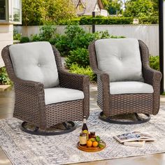 two wicker chairs sitting on top of a rug