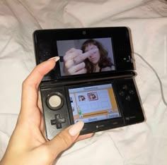 a person holding a nintendo wii game controller