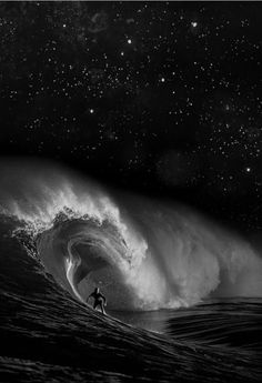 a man riding a wave on top of a surfboard