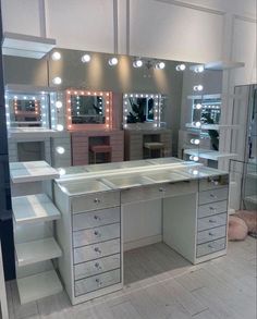 a vanity with lights and drawers in a room