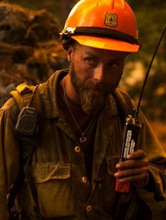 a man wearing a hard hat and holding a radio