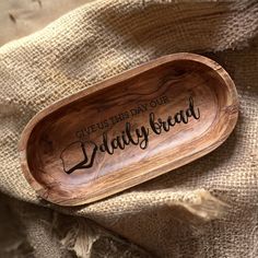 a wooden spoon that says give us this day our daily bread