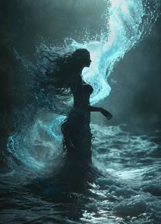 a woman standing in the water with her hair blowing