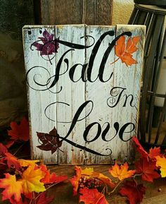 a wooden sign that says fall in love