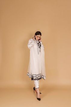 Introducing our sophisticated off-white silk kurta pant set, a timeless ensemble that seamlessly blends traditional elegance with contemporary style. Crafted with care, this outfit is perfect for occasions that demand grace and poise. The off-white silk kurta features a classic silhouette, providing both comfort and style. The intricate embellishments in black resham thread add a touch of sophistication, creating a beautiful contrast against the serene backdrop of the fabric. The careful detailing showcases skilled craftsmanship, making this ensemble a true work of art. Paired with the kurta are comfortable and chic pants, completing the look with a modern twist. The flowing silhouette of the pants enhances the overall grace of the outfit, making it suitable for various occasions. To eleva White Palazzo Set With Resham Embroidery And Straight Kurta, White Anarkali Palazzo Set, Elegant Chikankari Embroidery Palazzo Set For Navratri, Traditional Off White Long Sleeve Palazzo Set, Elegant Off White Kurta With Dupatta, White Chanderi Traditional Drape Sets, White Anarkali Kurta With Traditional Drape, White Palazzo Set With Sheer Dupatta And Straight Kurta, White Silk Anarkali Set