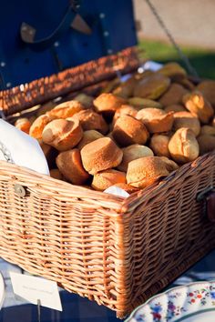 a wicker basket filled with bread sitting on top of a table