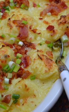 a casserole dish with bacon, green onions and cheese on it is ready to be eaten