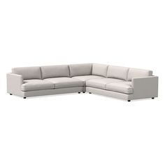 a white sectional couch sitting on top of a white floor