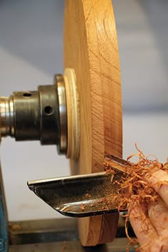 a person is working on a piece of wood with a hand held sawtoother