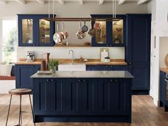 a kitchen with blue cabinets and counter tops