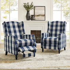 a living room with blue and white checkered chairs in front of a fire place