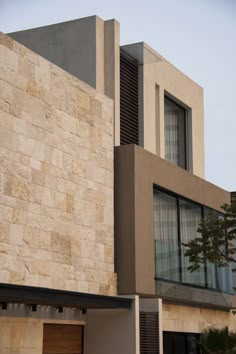 the building has two windows and is made out of stone blocks with shutters on each side