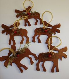 four brown reindeer ornaments hanging from twine