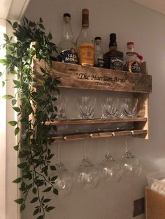 a wooden shelf holding wine glasses and bottles