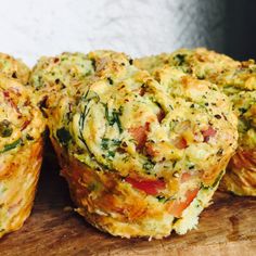 several muffins with various toppings on a cutting board