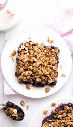 two white plates topped with blueberry baked oatmeal squares