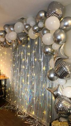 a room filled with balloons and disco balls