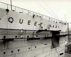 the queen mary ship is docked at the dock in black and white photo with people standing on it