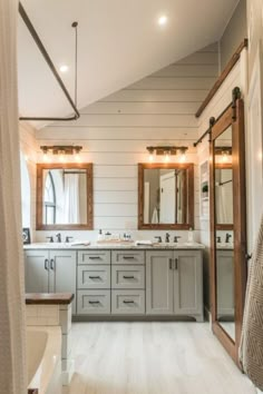 a large bathroom with double sinks and mirrors