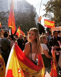 a group of people walking down a street holding flags