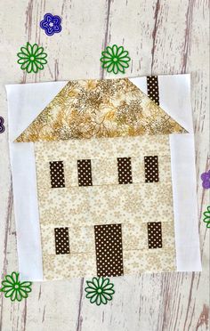 the house is made out of fabric and has green flowers on it, along with brown polka dots