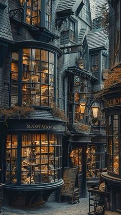 an old - fashioned book store is lit up in the dark by street lamps and windows