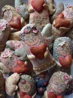 many different colored clay figurines with hearts and wings on top of each other