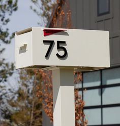 a white mailbox with the number 75 on it