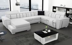 a modern living room with white leather furniture