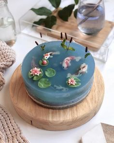 a blue cake decorated with koi fish and flowers