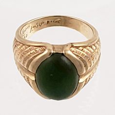 "This striking 14K gold ring features a large green jade stone and an engraved band that resembles a stylized fern or feather. Just the right combination of style and masculinity! Note that the inside of this ring has a lovers inscription and date 1974. Style: Classic, Masculine Vintage: 1970s Materials: 14K Gold, Green Jade Size: 10 Green Jade: 16mm x 12mm Width North to South: approx. 3/4\" Weight: 7.5 dwt / 11.6 g Condition: Very Good ASK ABOUT OUR FREE LAYAWAY! FREE FULLY INSURED PRIORITY SH Formal Green Engraved Signet Ring, Antique Green Emerald Ring With Polished Finish, Green Carved Rings For Formal Occasions, Formal Carved Green Ring, Engraved Oval Green Emerald Ring, Oval Engraved Green Emerald Ring, Green Oval Engraved Rings, Classic Green Engraved Signet Ring, Formal Green Carved Ring