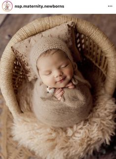 a baby is sleeping in a basket