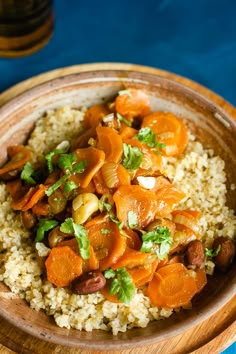 a wooden bowl filled with rice and vegetables