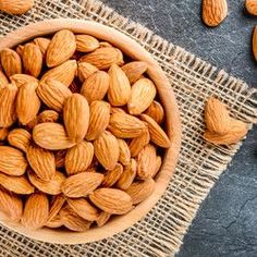 almonds in a wooden bowl on a table