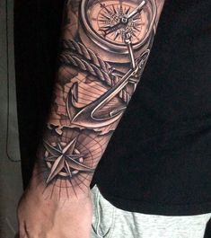 a man's arm with an anchor, compass and rope tattoo design on it