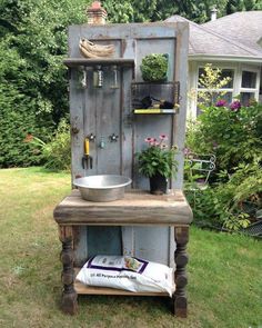 an old cabinet is turned into a potting planter in the yard with plants growing out of it