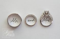 three wedding rings with the words mr and mrs written on them in cursive writing