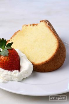 a piece of pound cake and a strawberry on a white plate with the rest of it