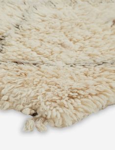 a shaggy rug with black and white designs on it's edges is shown in close up