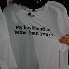 someone holding up a t - shirt that says, my boyfriend is better than yours