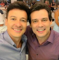 two men are smiling for the camera at a formal event