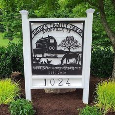 the sign for brown family farm in roxwell, pennsylvania is shown with trees and bushes