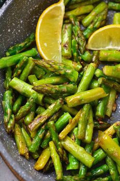 asparagus with lemon wedges in a bowl