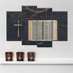 an open book with a cross and candles on top