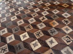 the floor is made up of many squares and designs on it, all in different colors