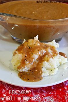 a white plate topped with mashed potatoes and gravy