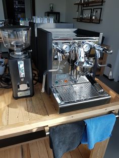 an espresso machine sitting on top of a wooden table