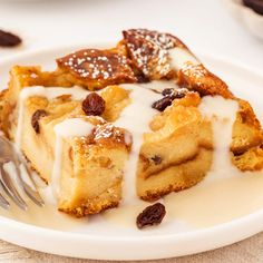 a piece of cake with icing and raisins on a plate