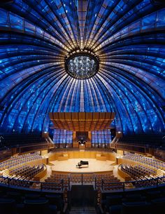 the interior of a concert hall with blue lights