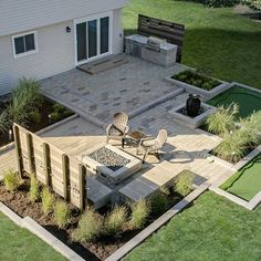 an aerial view of a patio with chairs and fire pit in the middle of it